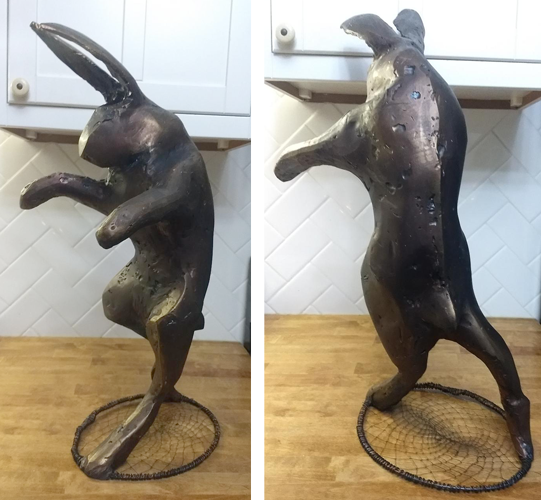 hare standing on a cobweb sculpture